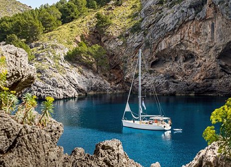 Ein Boot schwimmt in einem blauen Gewässer vor der Küste Mallorcas.