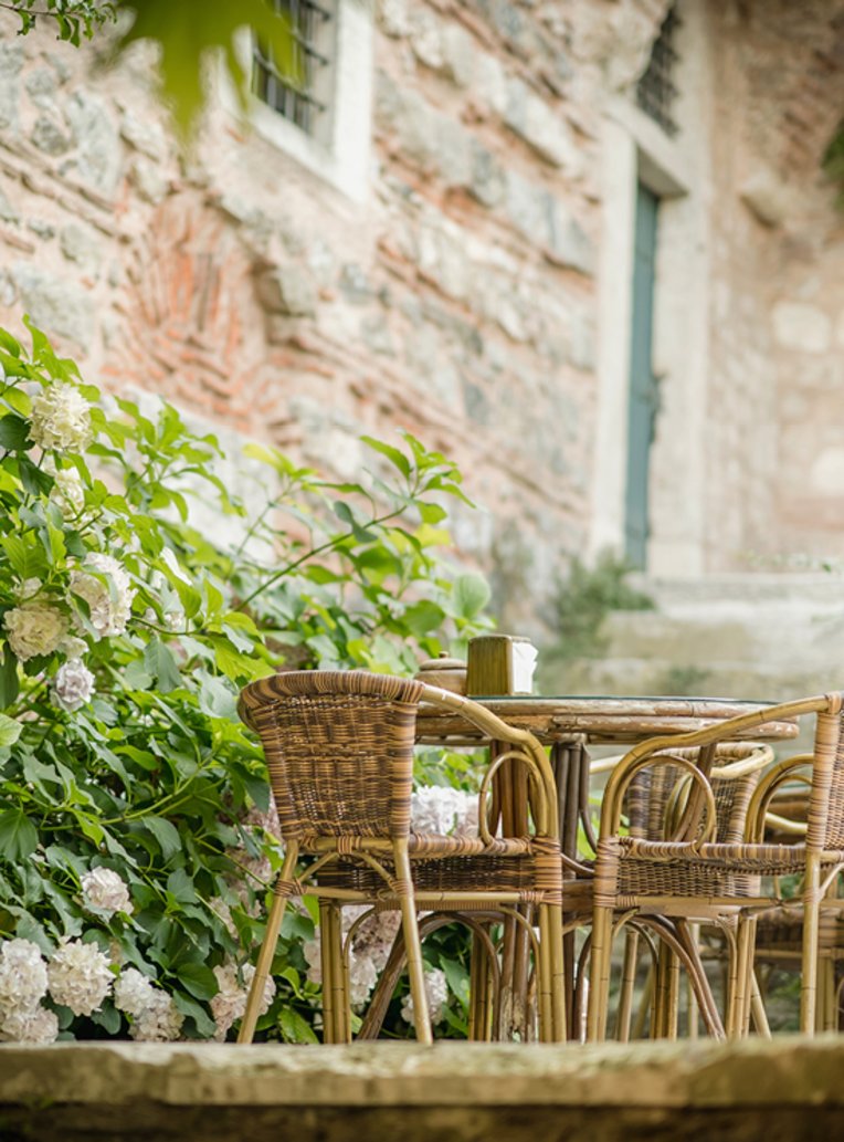  Ein Tisch mit Stühlen vor einem steinernen Gebäude in Istanbul.